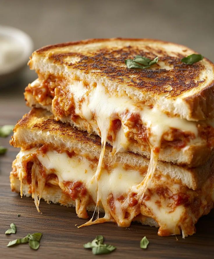 two grilled cheese sandwiches stacked on top of each other