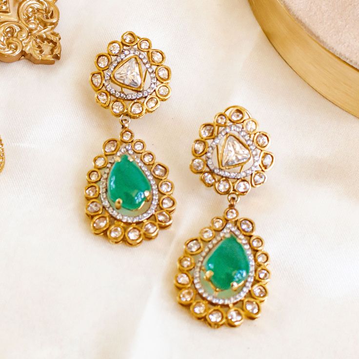 These earrings offer a sophisticated splash of color and a touch of elegance, making them a must-have accessory for any occasion! Vibrant hues of emerald, CZ and champagne stones blend seamlessly to create a captivating, aquatic-inspired design earrings. Approximate earrings length is. Gold-plated on high quality brass as base metal. Made by order. Kindly allow 5-7 weeks for the delivery of this item. For custom or urgent requests, please contact support@alacouture.com. *Please Note: We use faux stones and beads in all of our jewelry. Heritage Jewellery, Splash Of Color, Design Earrings, Waist Chain, Faux Stone, Head Accessories, Gift Card Shop, Base Metal, Men's Collection