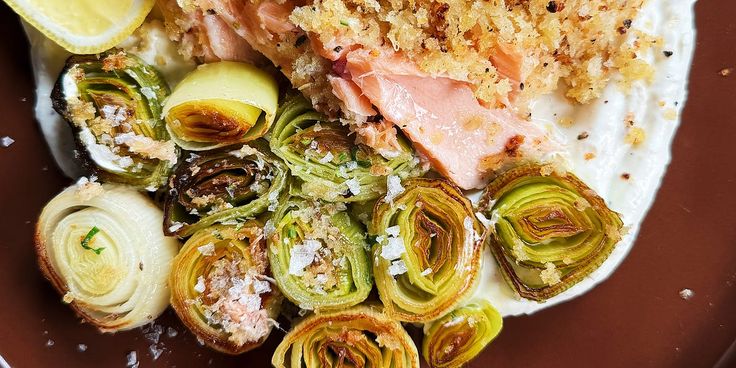 a plate with artichokes, brussel sprouts and salmon