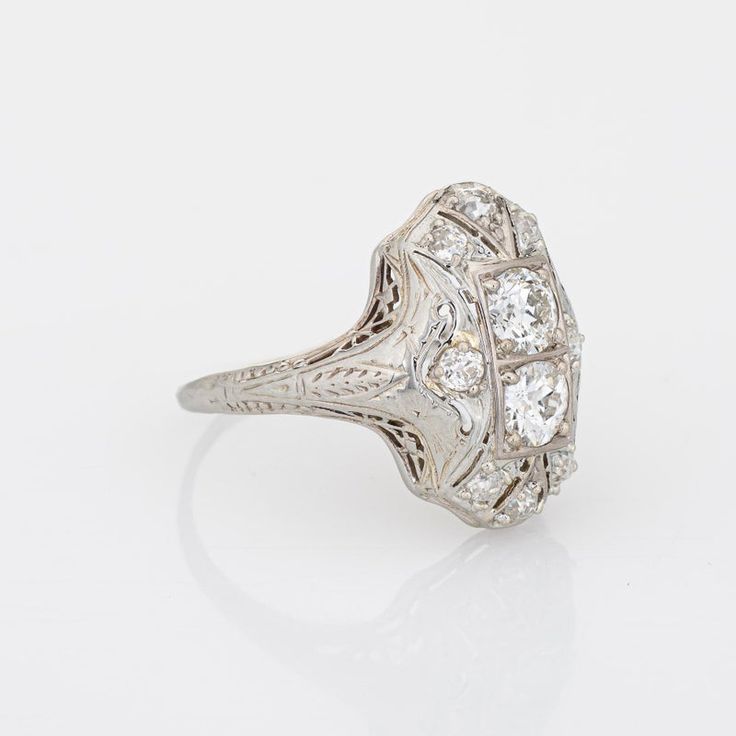 Elegant & finely detailed Belais Art Deco era ring (circa 1920s to 1930s) crafted in 14k white gold.   Two centrally mounted old European cut diamonds are estimated at 0.48 carats each. A further 8 old mine cut diamonds total an estimated 0.42 carats. The total diamond weight is estimated at 1.38 carats (I-J colour and VS2-I2 clarity).      Belais Brothers is a highly regarded and very collectible maker from the late 19th century to the early 20th century. The ring epitomises vintage charm and w Platinum Collectible Diamond Ring, Platinum Diamond Ring With Diamond Cut For Collectibles, Heirloom Brilliant Cut Diamond Ring Collectible, Classic Collectible Diamond Ring With Center Stone, Art Deco White Gold Diamond Ring In Platinum, Classic Collectible Rings With Diamond Accents, 14k White Gold Art Deco Diamond Ring, Classic Rings With Diamond Accents For Collectors, Heirloom 14k White Gold Diamond Ring