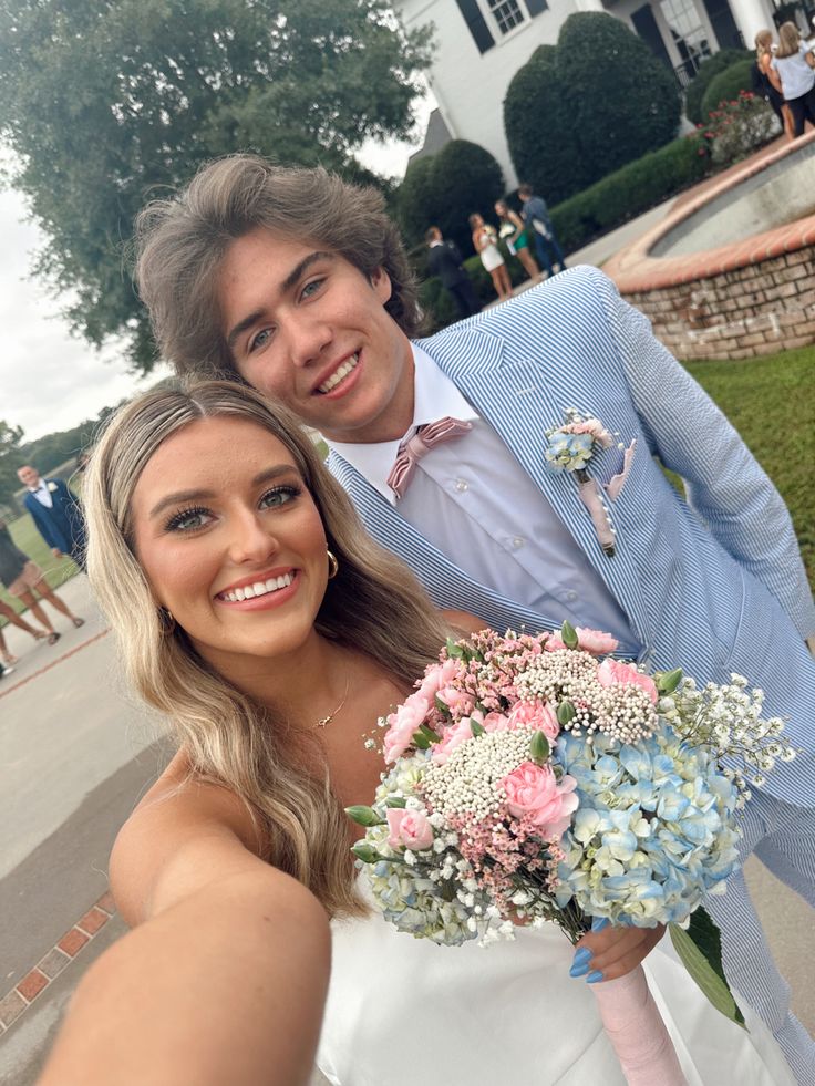 a young man and woman posing for a photo