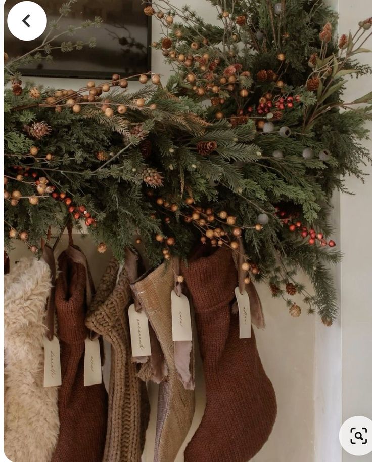 stockings hung on the wall with christmas decorations