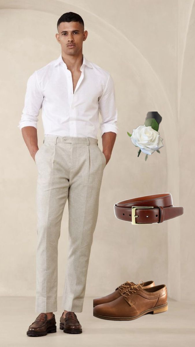 a man standing next to a pair of shoes and a flower on the ground with his hands in his pockets