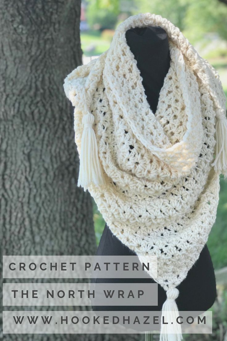 a crocheted scarf with tassels hanging from it