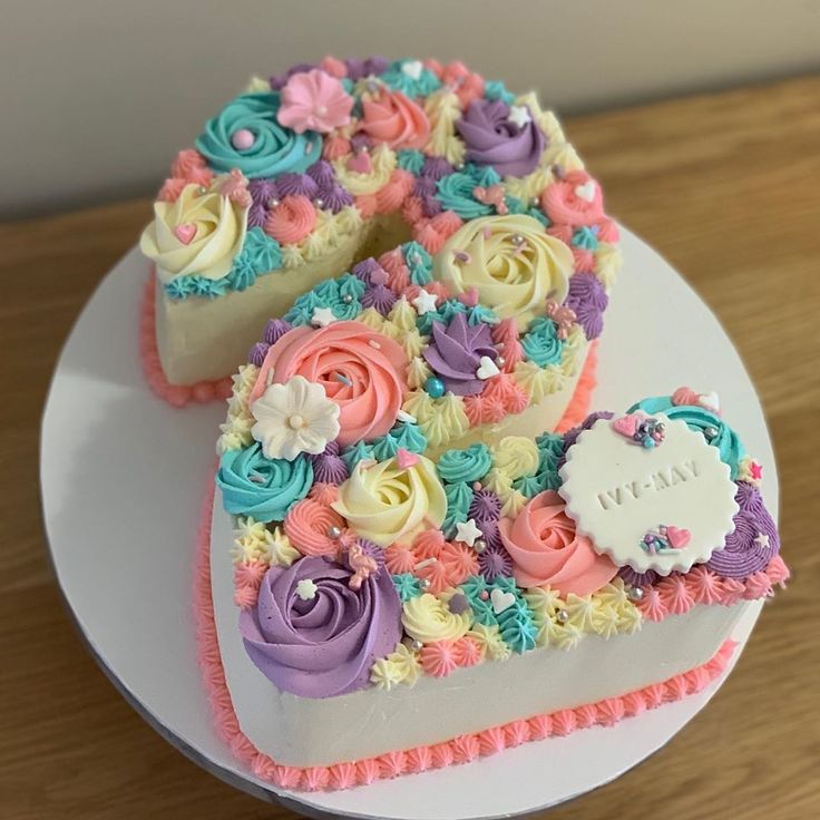 two heart shaped cakes decorated with flowers on a plate