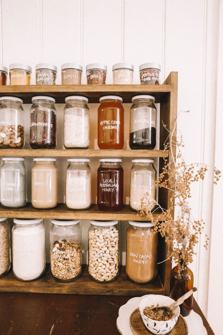 a shelf filled with lots of different types of jars on top of eachother