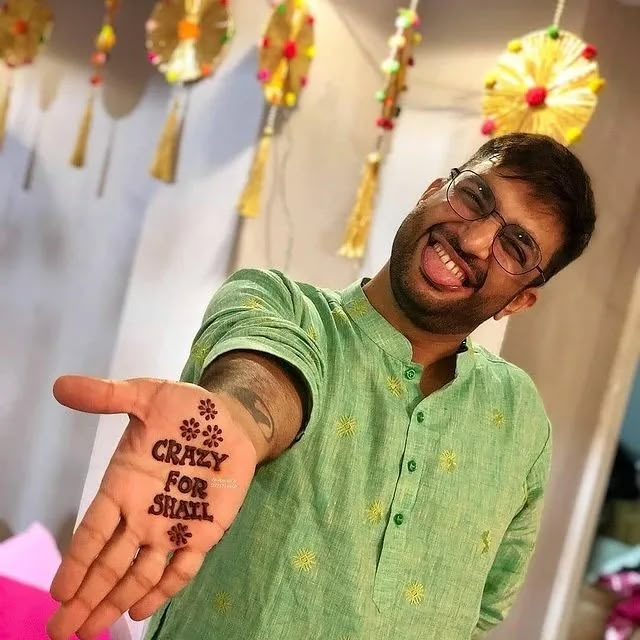 a man pointing at the camera with his hand in front of him that says crazy for india