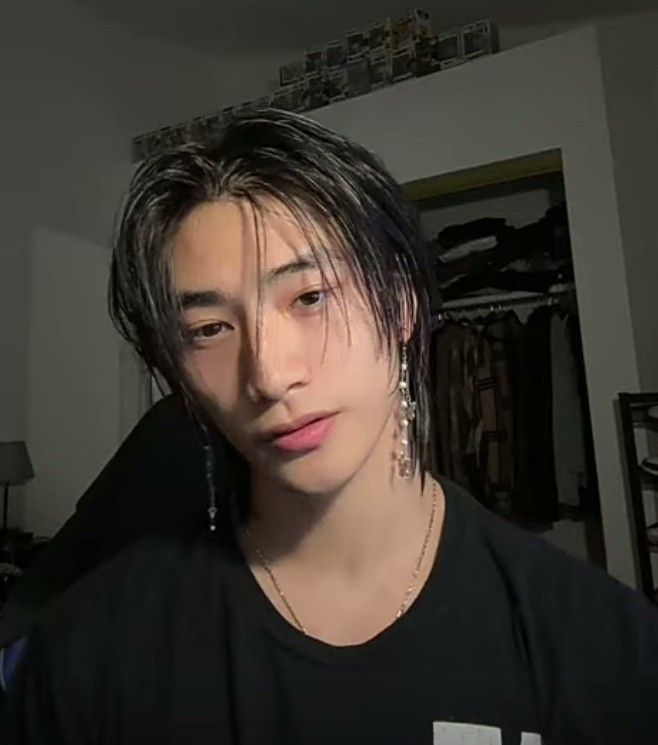 a young man with black hair and piercings