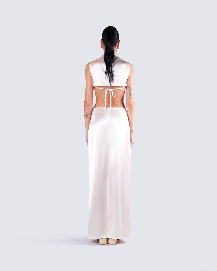 the back of a woman wearing a white dress