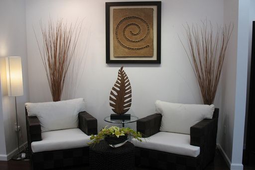 a living room with two couches and a coffee table in front of a painting on the wall