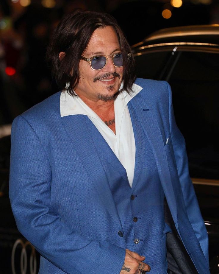 a man in a blue suit and sunglasses