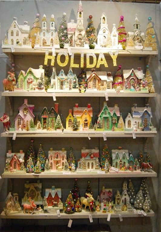 a display case filled with lots of christmas figurines on top of wooden shelves