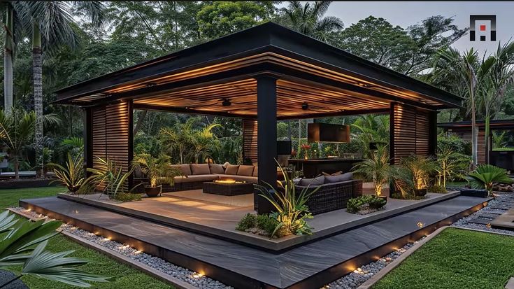 an outdoor living area with couches and lights on the roof, surrounded by greenery