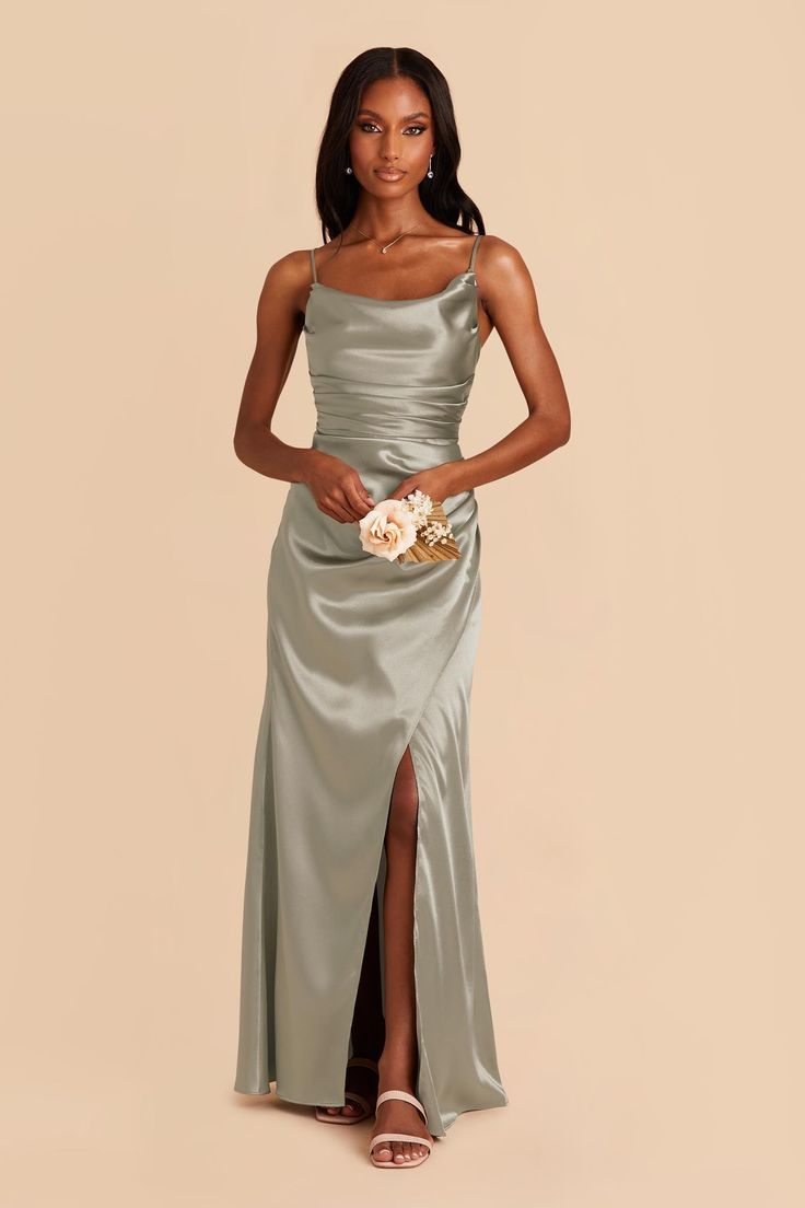 a woman in a silver dress holding a bouquet