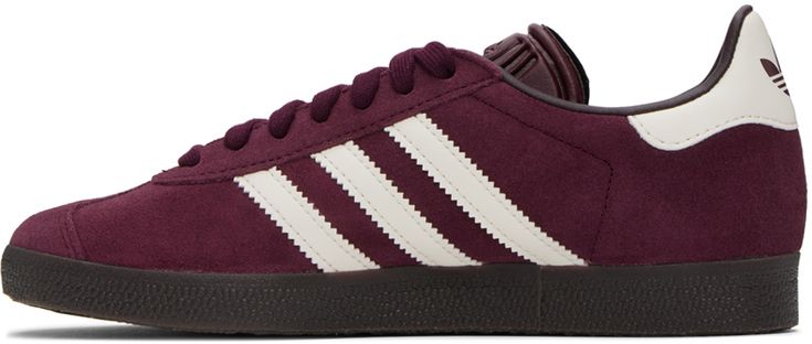 Low-top suede sneakers in burgundy. · Lace-up closure · Logo embossed at tongue · Padded collar · Signature serrated stripes at sides · Logo embossed at heel tab · Grained faux-leather lining · Treaded rubber sole Supplier color: Maroon/Chalk white Leather Burgundy Sneakers With Rubber Sole, Purple Suede Lace-up Sneakers, Sporty Burgundy High-top Sneakers, Sporty Burgundy Sneakers For Sports, Sporty Burgundy Sneakers, Burgundy Sporty Sneakers For Sports, Casual Purple Suede Sneakers, Burgundy Sneakers With Contrast Sole And Round Toe, Sporty Burgundy Sneakers With Rubber Sole