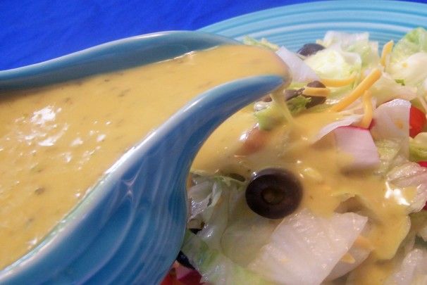 a blue bowl filled with soup and vegetables