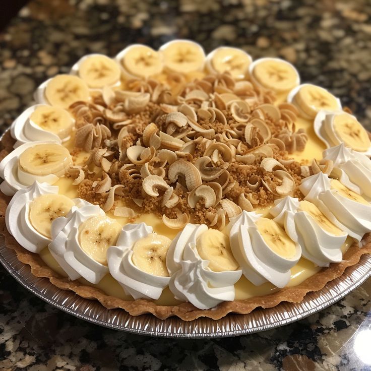 a pie topped with bananas and whipped cream