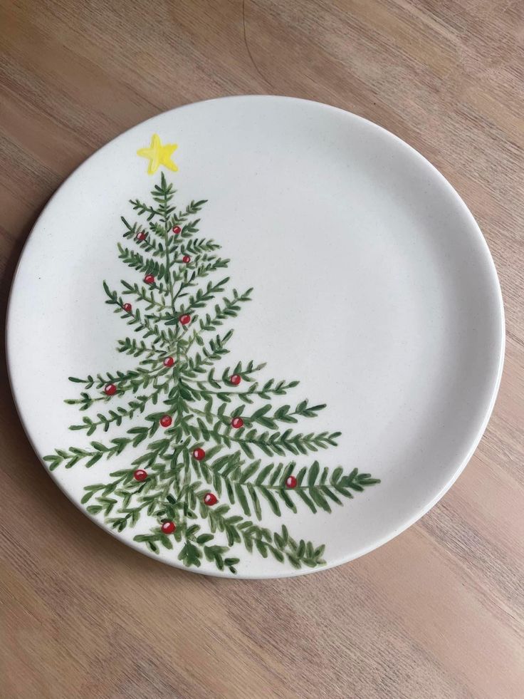 a white plate with a christmas tree painted on it