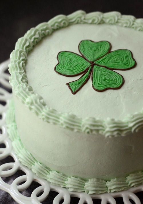 a cake decorated with a green shamrock leaf