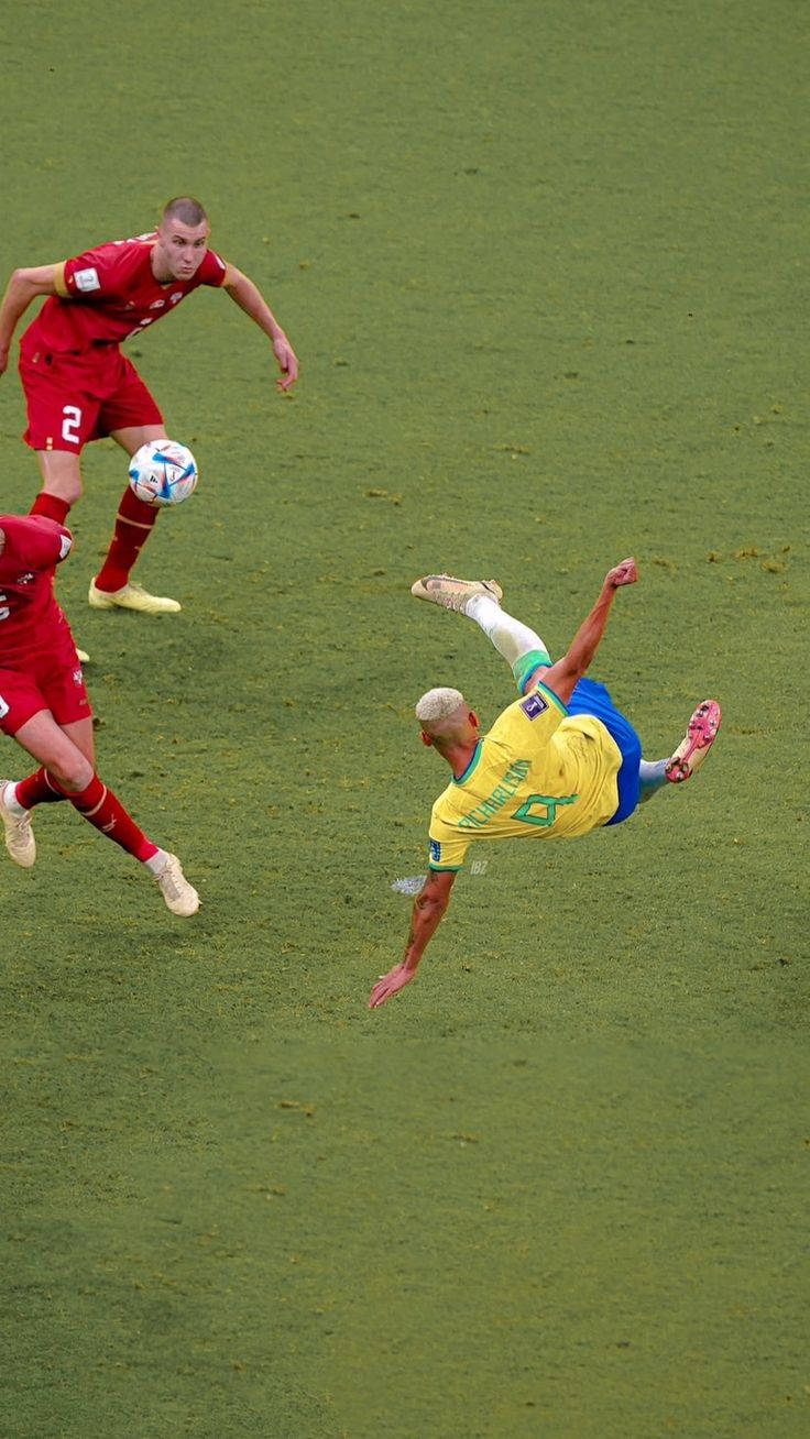 two soccer players colliding for the ball during a game