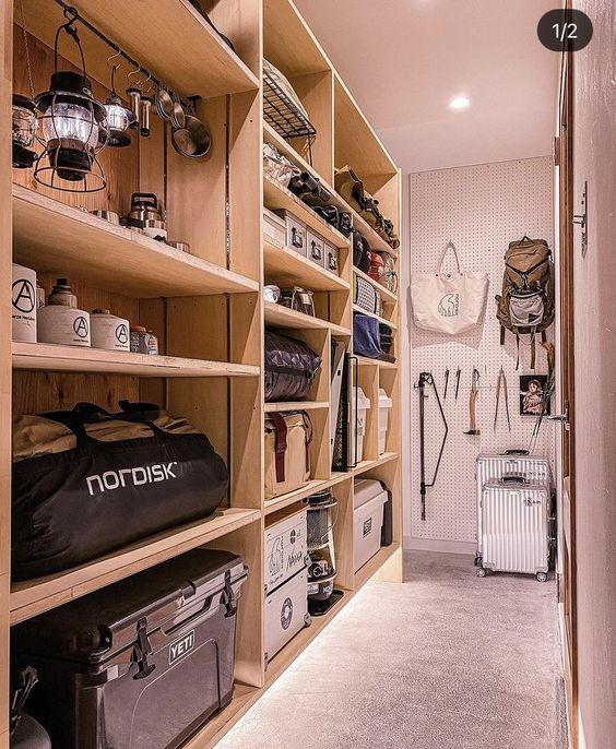 the inside of a storage room with lots of items on shelves and bags hanging up against the wall