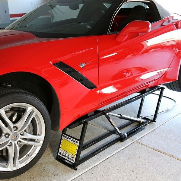 a red sports car parked in a garage