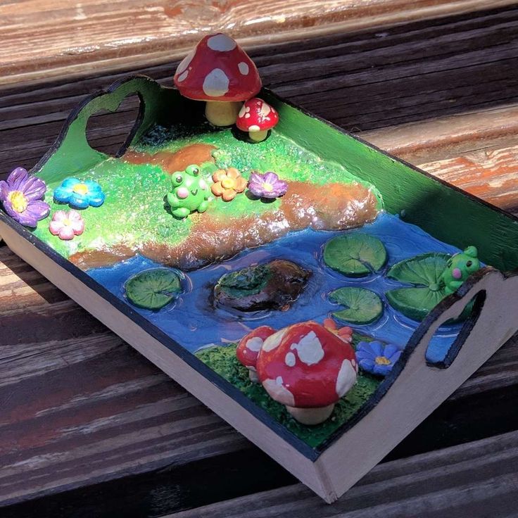 a cake in the shape of a mushroom sitting on top of a book with water lilies