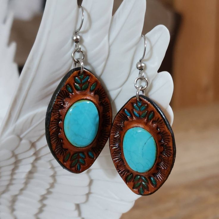 Hand picked unique upcycled beads to make these unique standout one of a kind leather earrings.  Sky blue Turquoise 20mm bead Compressed color inhansed turquoise 20mm diamond bead -Surgical Steel hooks -Stainless steel bails - doubled leather -Briar brown finished  Find more of my rustic my hand made designs ## https://www.etsy.com/shop/KCsDesignsShop $ this site has coupon codes -message for any questions you may have Handmade Leather Turquoise Earrings, Handmade Turquoise Leather Earrings, Handmade Leather Earrings In Turquoise, Bohemian Turquoise Leather Earrings, Handmade Southwestern Leather Earrings, Artisan Turquoise Pierced Jewelry, Nickel-free Turquoise Jewelry For Crafting, Unique Beaded Leather Jewelry, Blue Leather Bohemian Earrings