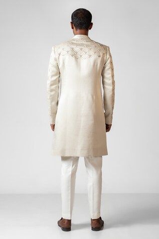 Ivory double panelled achkan with resham french knots and pani salli embroidery. Paired with solid straight pant. - Aza Fashions Fitted Off White Embroidered Traditional Wear, Fitted Embroidered Off White Traditional Wear, Fitted Traditional Wear With Embroidered Border For Formal Occasions, Traditional Fitted Kurta With Pearl Embroidery, Fitted Beige Sherwani With Chikankari Embroidery, Fitted Off-white Sherwani With Chikankari Embroidery, Fitted Off White Sherwani With Chikankari Embroidery, Fitted Off White Kurta For Transitional Season, Fitted Cream Nehru Jacket With Resham Embroidery