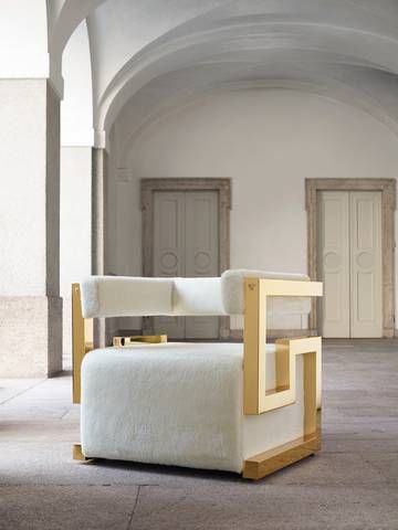 a white chair sitting on top of a floor next to two doors in a building