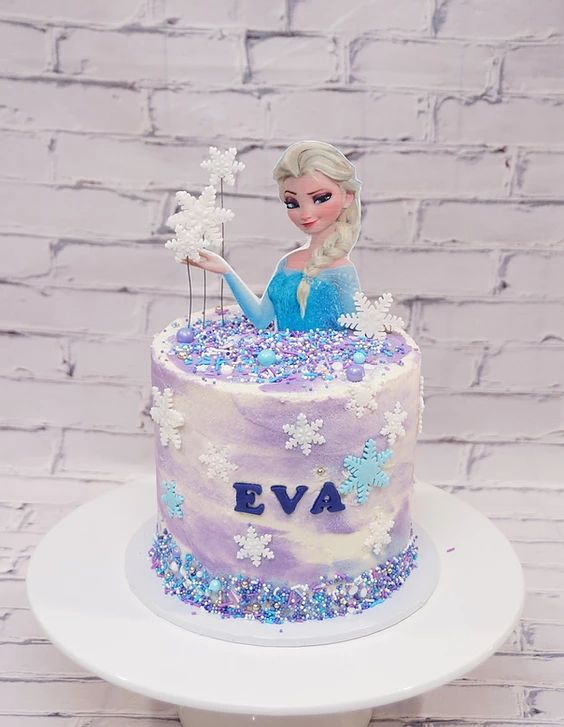 a frozen princess cake on a white plate