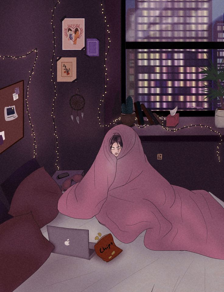 a woman wrapped up in a blanket on top of a bed next to a laptop computer