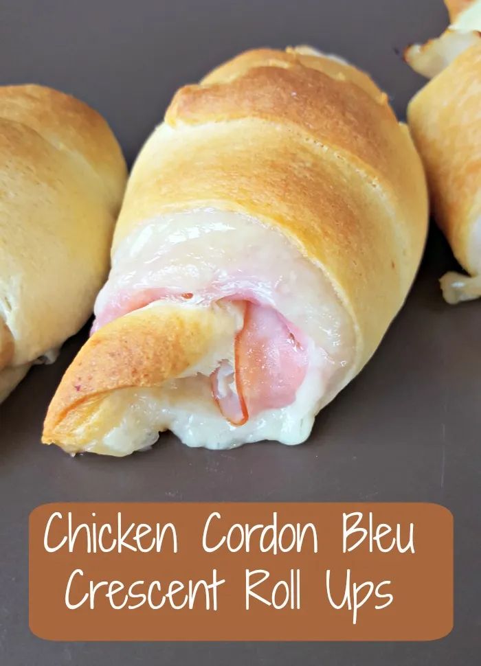 chicken cordon bleu crescent roll ups with cheese and ham on top, ready to be eaten