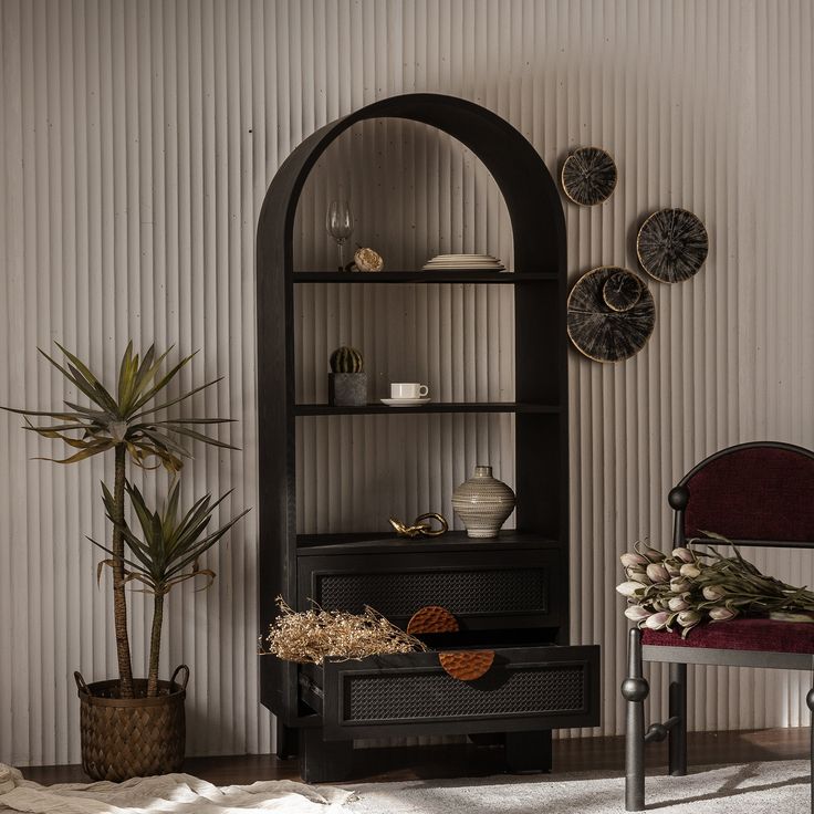 a room with a chair, shelf and potted plant