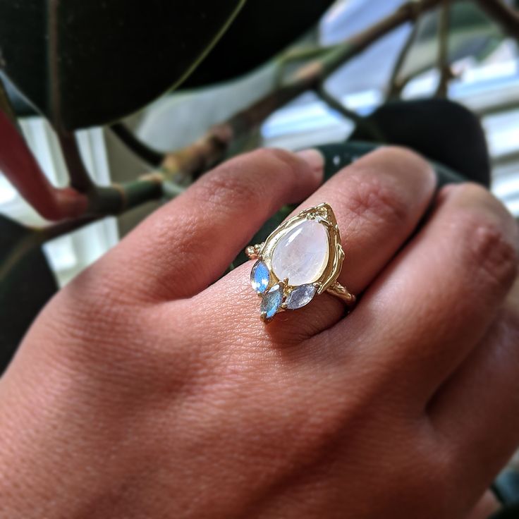 Moonstone, Labrodorite, and 14K Yellow Gold come together in this one of a kind statement ring. Organic texture abounds! A pretty cocktail ring for someone who likes to make a statement. One of a kind. Pretty Cocktail, Dope Jewelry Accessories, Pretty Cocktails, Shiny Rings, Jewel Wedding, Moonstone Engagement, Moonstone Engagement Ring, Dope Jewelry, Gems And Minerals