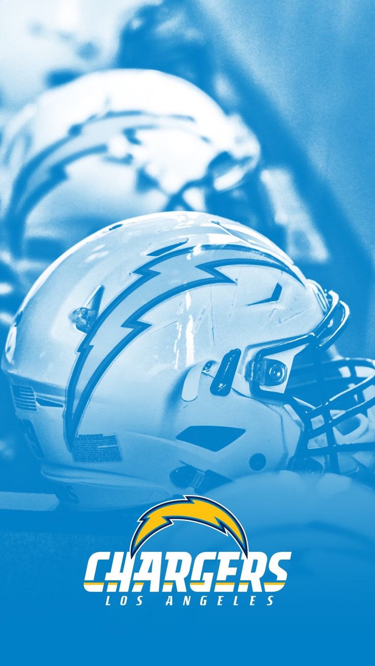 two football helmets sitting on top of each other with the chargers logo in front of them