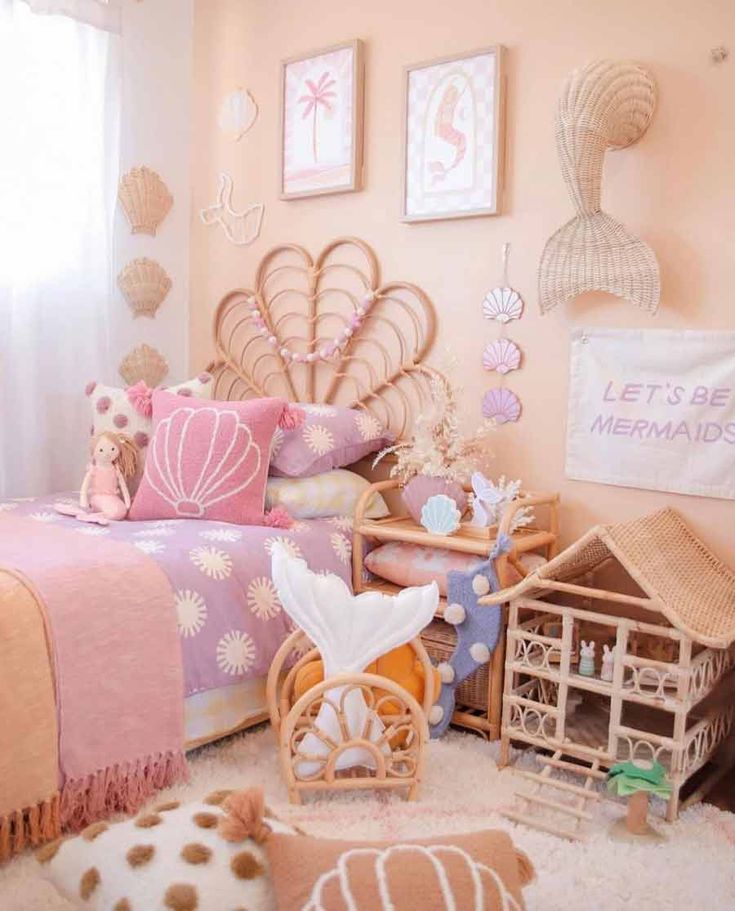 a bedroom with pink walls and lots of toys on the floor in front of it