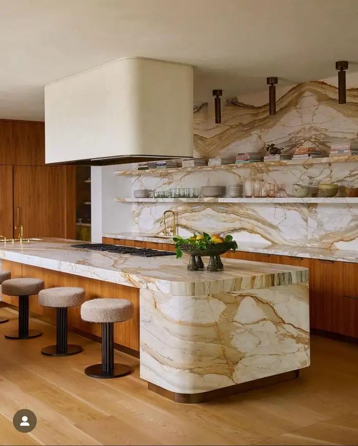 a kitchen with marble counter tops and stools