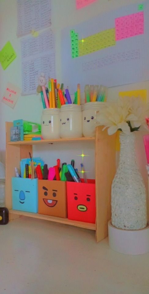 there is a wooden shelf with many items on it and a vase filled with flowers