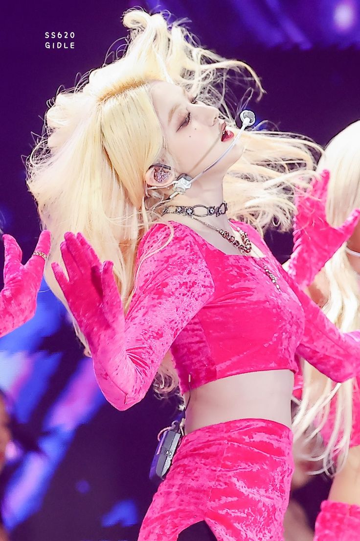 lady in pink outfit performing on stage