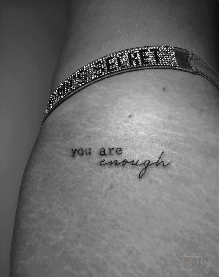 a woman's stomach with the words you are enough written on it