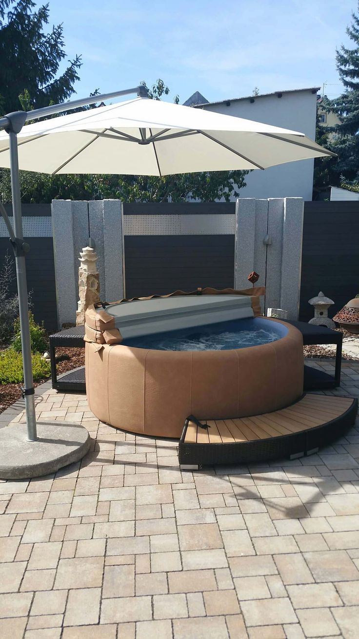 a hot tub with an umbrella over it