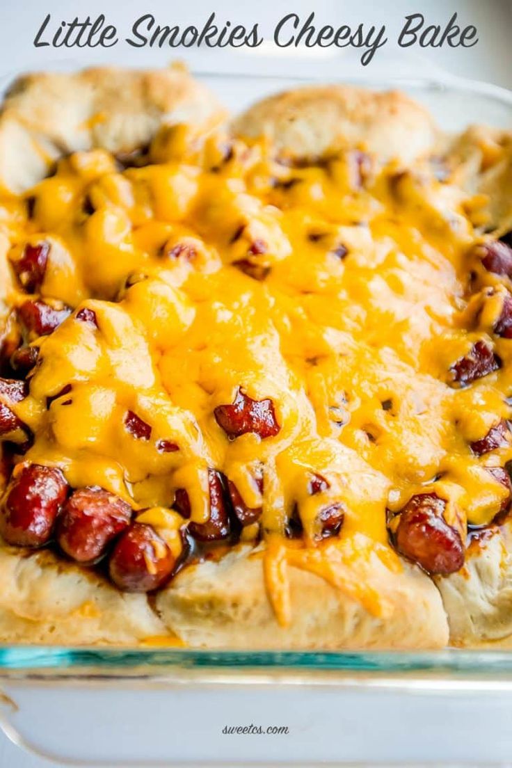 a casserole dish with hot dogs and cheese on top, ready to be eaten