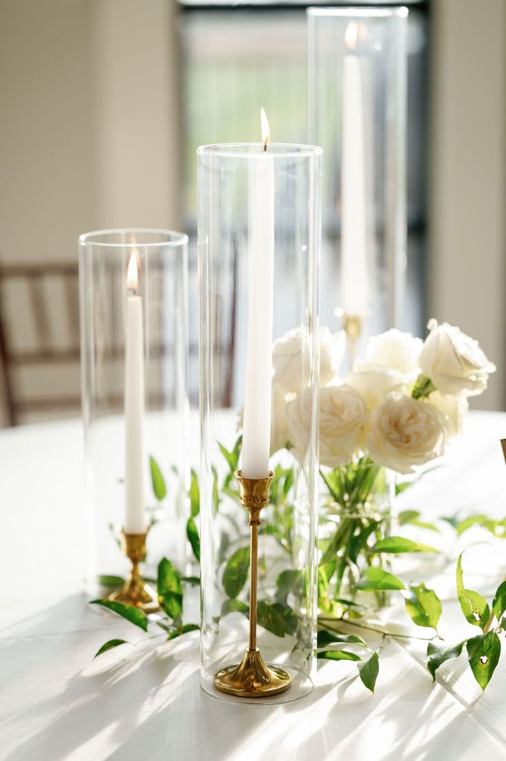 candles and flowers on a white table cloth