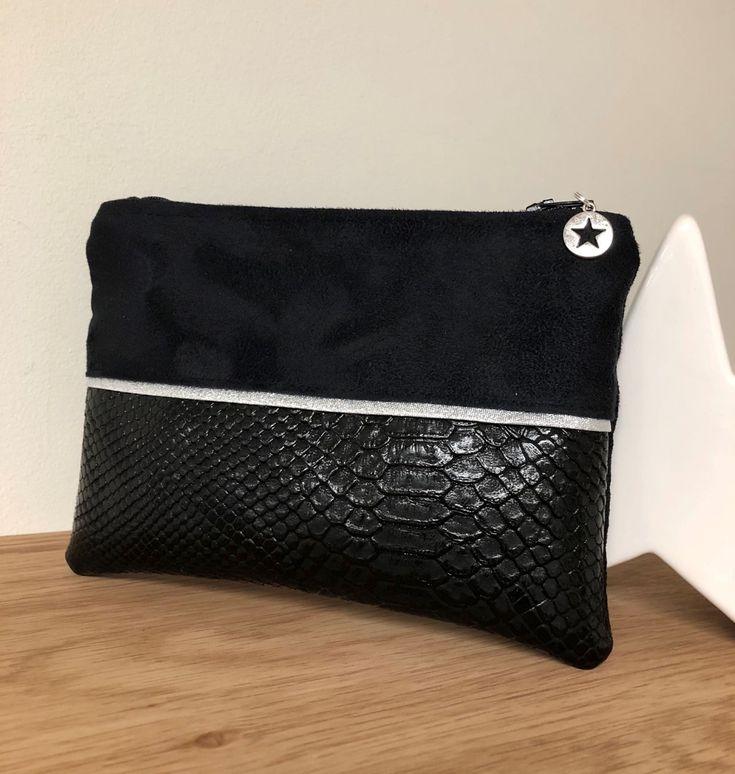 An elegant black and silver reptile-look coin purse, a small flat pouch to slip into your bag, or to give as a gift, it's always a useful, customizable present!  This wallet is designed in black suedette with a very velvety touch, suede effect and imitation reptil leather on the front, enhanced with a silver glittering border.  This small pocket closes with a matching zip to which is hung a silver star charm.  It is entirely lined in black cotton with sequined "Lesfilsdisa" flocking. dimensions: Black Pouch Clutch As Gift, Black Rectangular Coin Purse Gift, Black Clutch Wallets As Gift, Black Clutch Pouch For Gifts, Black Zipper Pouch Coin Purse Clutch, Black Zippered Pouch For Gifts, Black Zipper Pouch As Gift, Black Zipper Pouch For Gift, Black Zipper Clutch Coin Purse