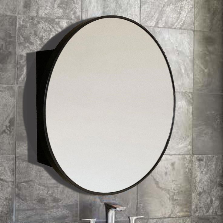 a round mirror mounted to the side of a wall