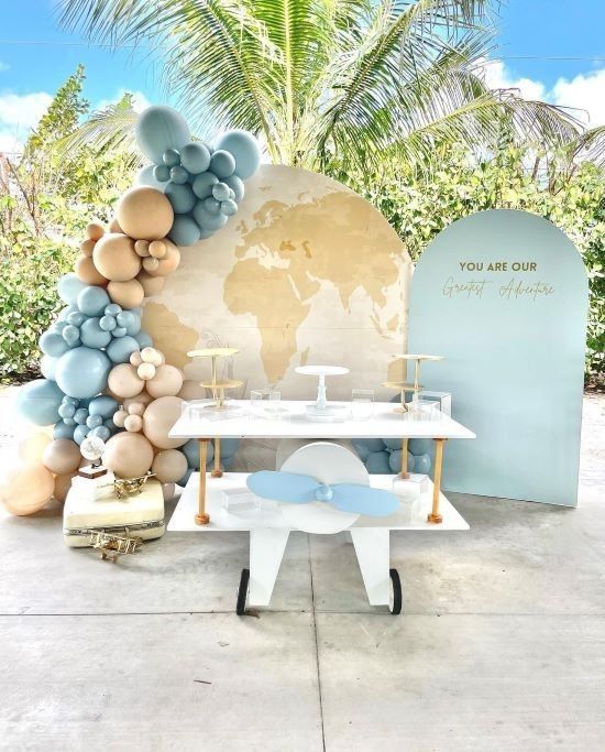 a table with balloons on it and a world map in the backgroung