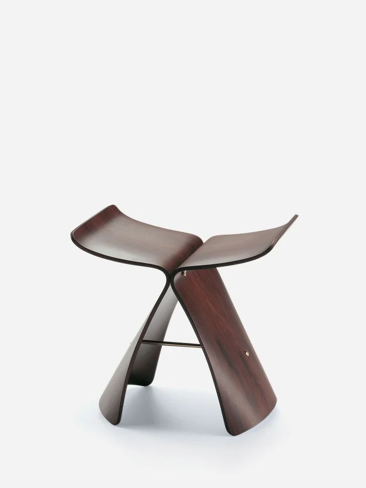 an unusual wooden stool with curved legs