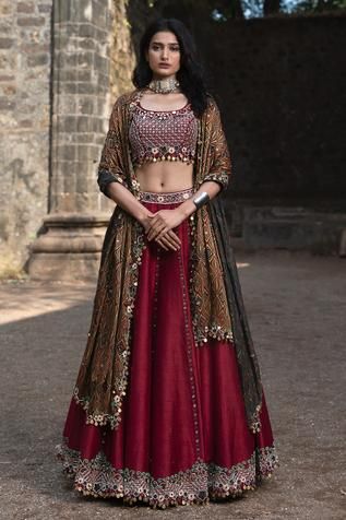 Maroon lehenga embellished with mirror, coin tassel hem and embroidery. Paired with embroidered blouse and ajrakh print dupatta.
Component: 3
Pattern: Embellished
Type Of Work: Mirror Work
Neckline: U-neck
Sleeve Type: Sleeveless
Fabric: Raw Silk
Color: Maroon
Other Details: 
Coin tassel details
Bead and thread work embroidery
Occasion: Wedding - Aza Fashions Maroon Blouse Lehenga, Lehenga Couture, Patola Lehenga, Designer Chaniya Choli, Navratri Outfits, Maroon Lehenga, Reuse Ideas, Desi Fits, Mehendi Outfit