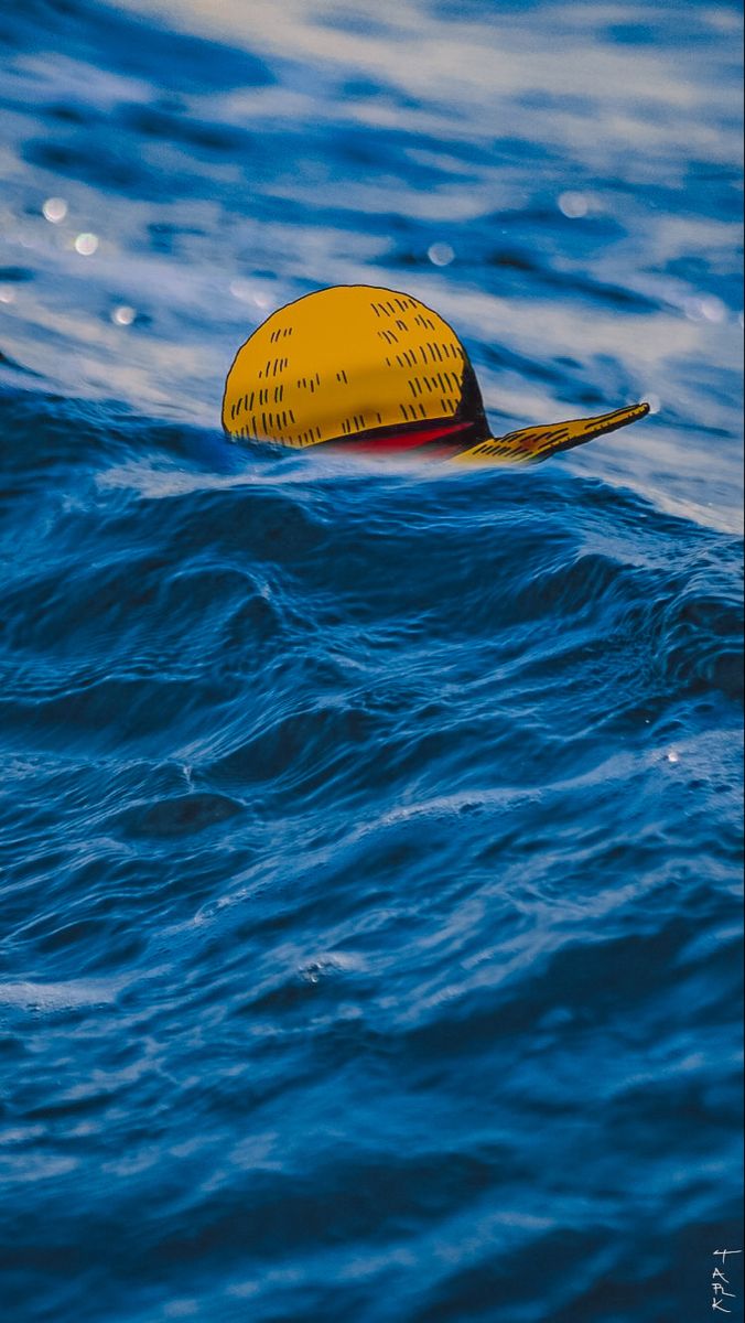 a yellow buoy floating on top of the ocean